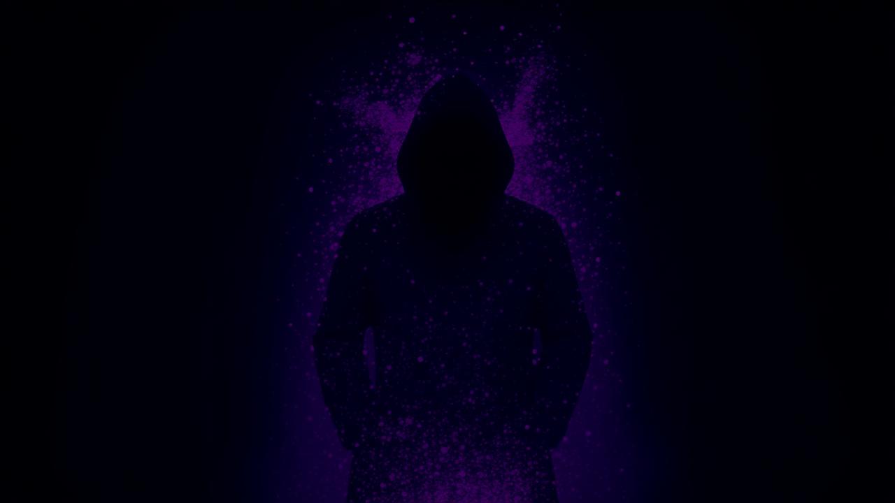 Anonymous silhouette dissolving into purple particles on a deep violet background.